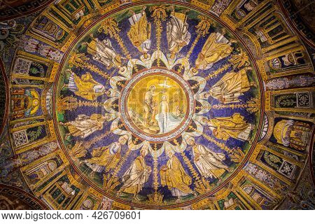 Ravenna, Italy - October 14, 2016: Mosaic cupola in the Neoniano Baptistery in Ravenna - John the Baptist baptizing Jesus and the Apostles around, cerca 5th century