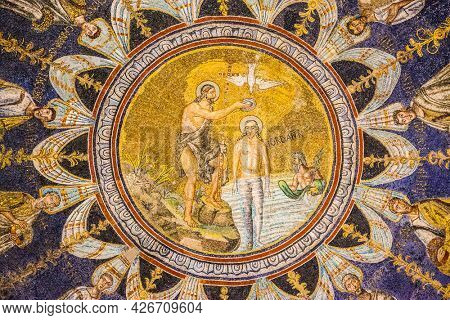 Ravenna, Italy - October 14, 2016: John the Baptist baptizing Jesus - mosaic on the ceiling in the Neoniano Baptistery in Ravenna (cerca 5th century)
