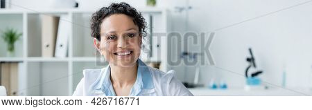 African Amercan Doctor Smiling At Camera In Clinic, Banner