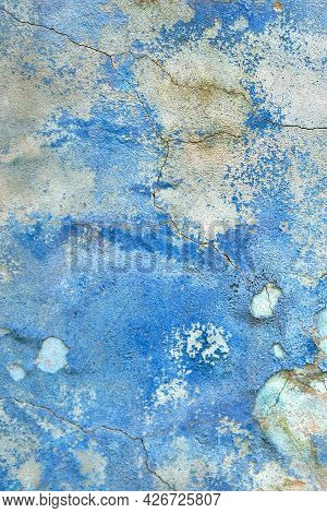 Wall With The Blue Whitewash Falling Off Fragment With Cracks As A Background Texture. Old Paint On 