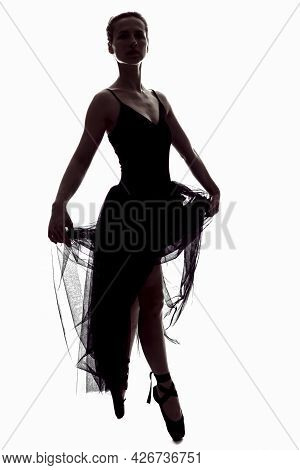 Caucasian Ballet Dancer In Body Suit And Flying Dress Posing Against White Background.