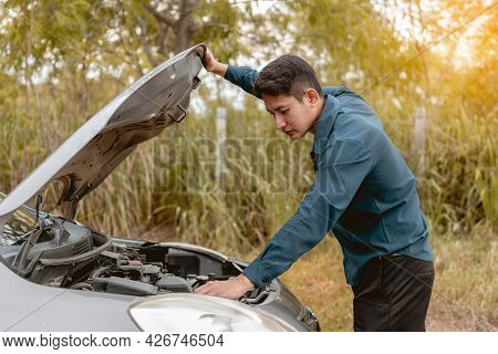 Man Open Car Hood For Repair As Maintenance Service. Man Trying To Check A Car Engine, Looking Insid