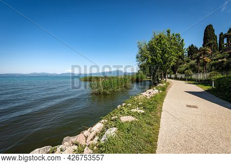 Bicycle And Pedestrian Lane On The Coast Of Lake Garda That Connects The Towns Of Lazise, Cisano, Ba