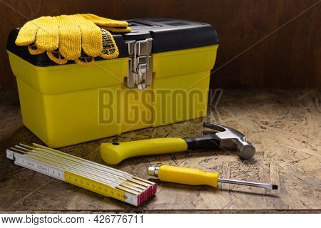 Construction tools and toolbox on wooden tablel background texture. Tools kit and tool box