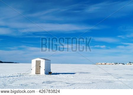 Ice Fishing On A Frozen Harbor Along The Coast Of Prince Edward Island, Canada.