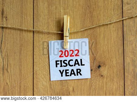 2022 Fiscal New Year Symbol. White Paper With Words '2022 Fiscal Year', Clip On Wooden Clothespin. B