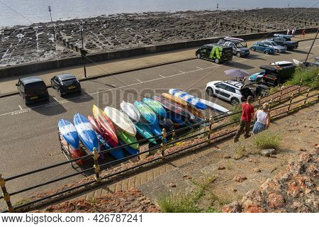 Old Hunstanton, Norfolk, England - June 13, 2021. Canoes Tidy And Upside Down On An Iron Platform.