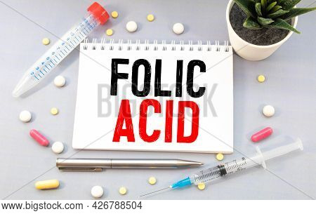 Folic Acid. Medicine Concept Yellow Paper Sticker With Inscription Folic Acid And Stethoscope, Medic