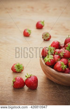 Old Wooden Bowl Filled With Succulent Juicy Fresh Ripe Red Strawberries On An Old Wooden Textured Ta