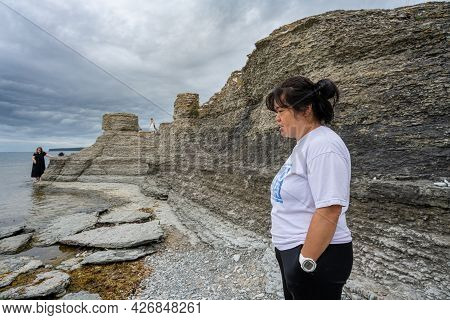 June 6, 2021 - Borgholm, Sweden: People Enjoy Beautiful Limestone Formations With A Dramatic Sky In 