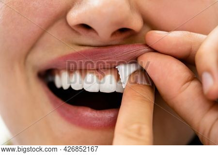 Woman Chewing Wet Moist Nicotine Tobacco Snus Product