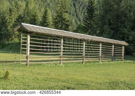 Traditional Slovenian Hayrack (kozolec). Wooden Construction For Drying Hay.
