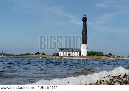 Sorvesaar, Estonia-06.21.2021: Lighthouse At The End Of Sorve Saar Peninsula. Tall Beacon Of Light F