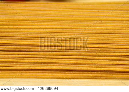 Long Raw Fresh And Healthy Macaroni Pasta Foot Background, On The Cutting Board