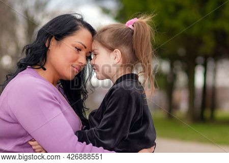 One Lonely Upset Mother Touching With Foreheads With Daughter, At Evening Park Outdoors.summer Eveni