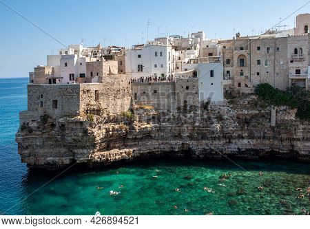Polignano, Italy - September 17, 2019: People Relax And Swimming On Lovely Beach Lama Monachile In P