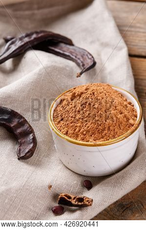 Dry Carob Pods And Carob Powder On Linen Napkin, Natural Background