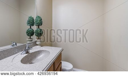 Pano Interior Of A Plain Bathroom With Vanity Sink And Toilet Bowl