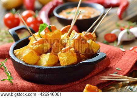 Spanish Patatas Bravas With Spicy Chili Sauce, A Traditional Appetizer And Bar Food