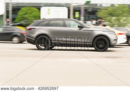 Moscow, Russia - May 2021: Brand New Range Rover Velar Side View. Sport Suv Gray Color Driving Again