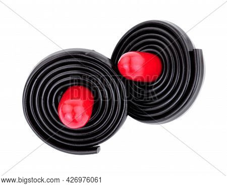 Liquorice Spinning Tops, Soft Liquorice Strips Wrapped Around A Red Liquorice Torpedo Isolated On A 