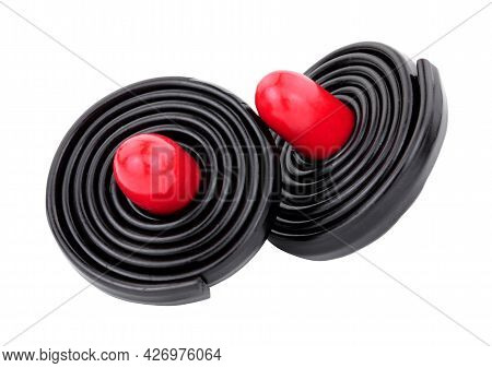 Liquorice Spinning Tops, Soft Liquorice Strips Wrapped Around A Red Liquorice Torpedo Isolated On A 