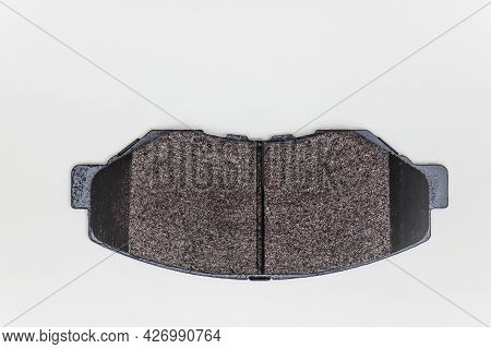 One Brake Pad On A Flat Surface. Set Of Spare Parts For Car Brake Repair. Details On White Backgroun