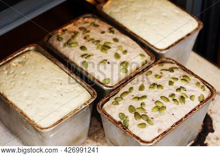 Baking Homemade Bread In The Oven. Dough In A Bread Pan. Dough In A Metal Form For Baking Bread. 
So