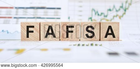 Word Fafsa Made With Wood Building Blocks On Background From Financial Graphs And Charts