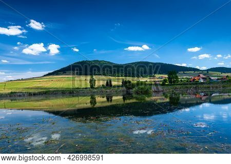 Miercurea Ciuc, Romania- 17 July 2021: Sumuleu Mountain Reflecting In A Small Pond, One F The Most V