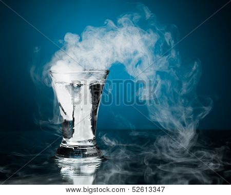 shot glass of vodka with ice vapor