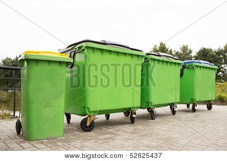 Green garbage containers in a row