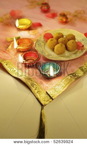 Indian sweets with traditional clay lamps