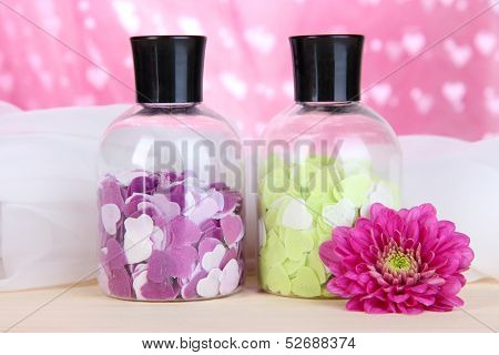 Aromatherapy minerals - colorful bath salt on pink background