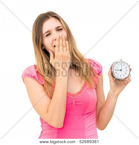 Yawn-beautiful young woman holding alarm clock 