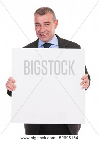 business man smiling for the camera while holding a small square pannel with both hands. on a white background