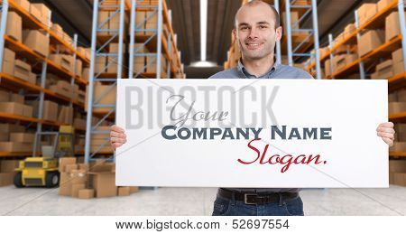A man holding a blank board in a distribution warehouse, ideal for inserting your own message