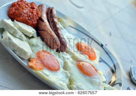 Appetizing breakfast with fried eggs  and fried sausages