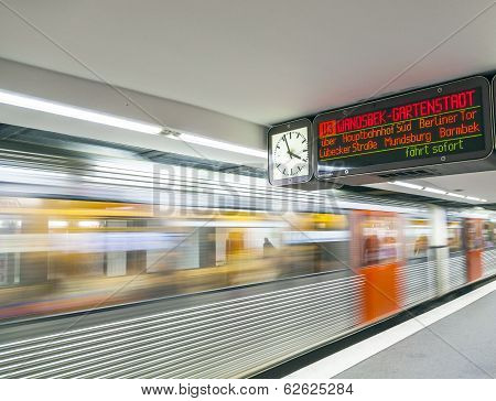 People In The Metro Station With Train In Motion