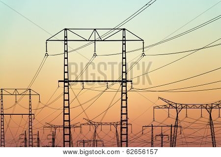 Electricity Pylons On Colorful Evening Sky