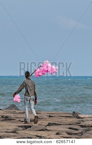PONDICHERRY, INDIA - FEBRUARY 2, 2013: Unidentified Indian street vendor of candyfloss