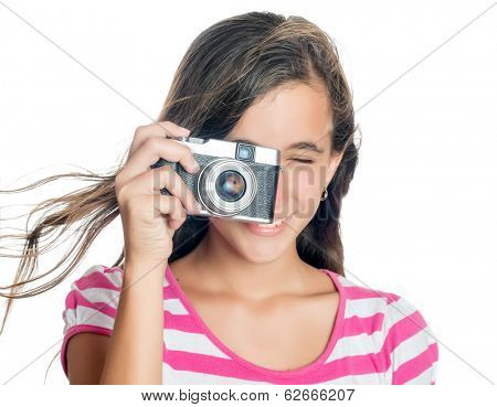 Beautiful young girl taking a picture with a vintage looking  compact camera looking through the viewfinder (isolated on white)