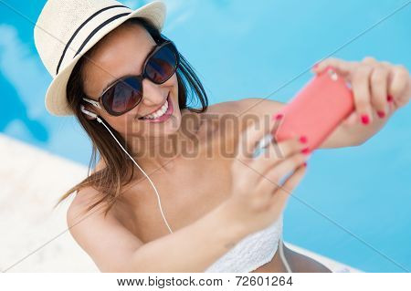 Beautiful Girl Taking A Selfie At The Swimming Pool.