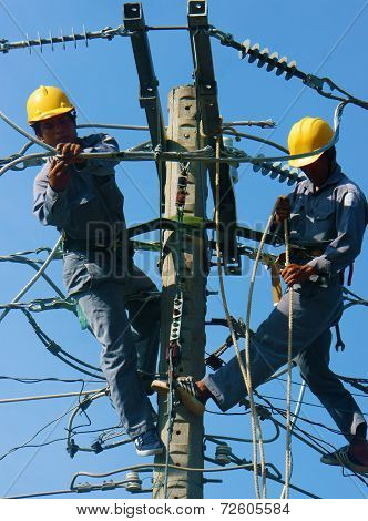 Asian Electrician Climb High, Work On Electric Pole