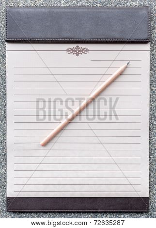 Blank Notepad With Pencil On The Brown Clipboard.