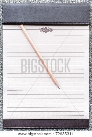 Blank Notepad With Pencil On The Brown Clipboard.