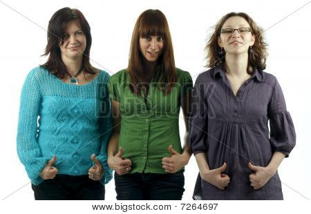 Portrait of three young women giving the thumbs-up sign