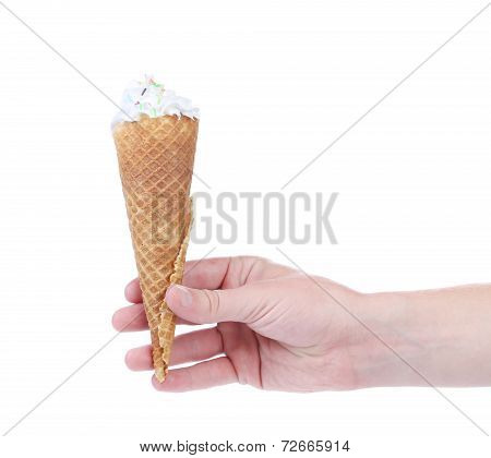 Hand holds empty ice cream corn.