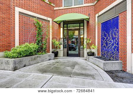 Brick Residential Building. Entance Porch With Waterfall