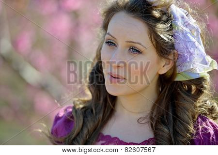 young beautiful woman portrait on field in summer